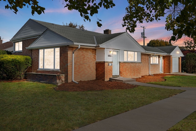 view of front of house with a yard and a garage