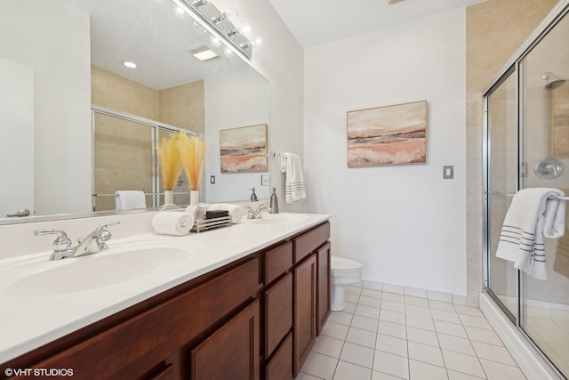 bathroom featuring toilet, vanity, tile patterned floors, and walk in shower