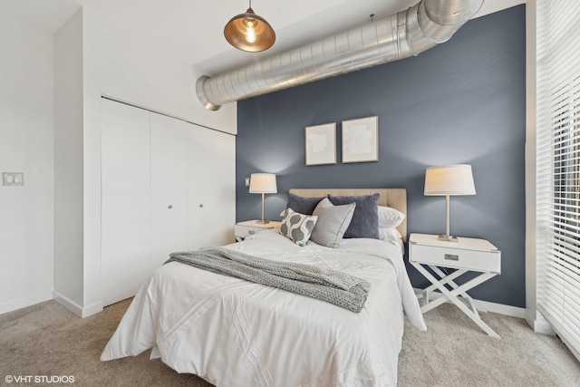 bedroom with a closet and light colored carpet