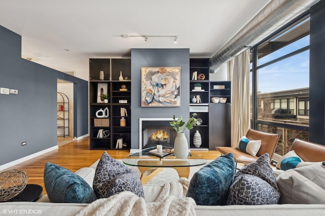 living room featuring light hardwood / wood-style floors and built in features