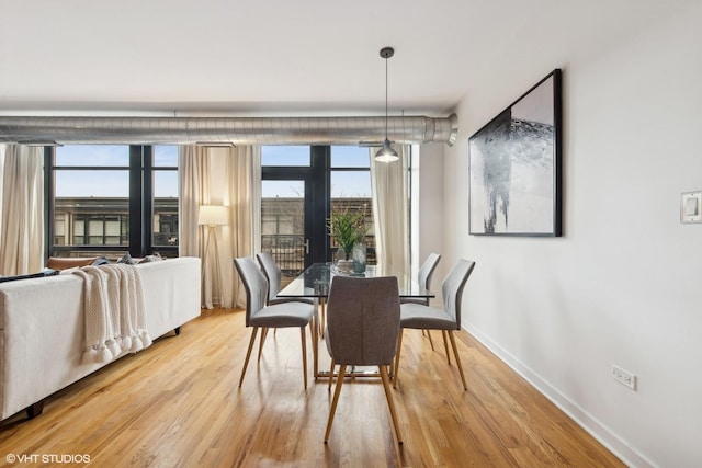 dining space with hardwood / wood-style floors