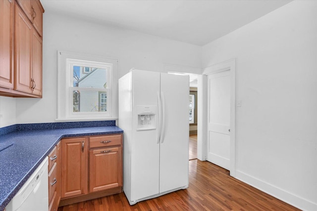 kitchen with hardwood / wood-style floors and white appliances