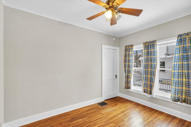 spare room with ceiling fan, hardwood / wood-style floors, and ornamental molding