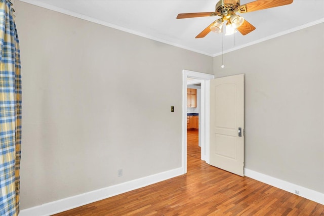 unfurnished room featuring ceiling fan, ornamental molding, and hardwood / wood-style flooring