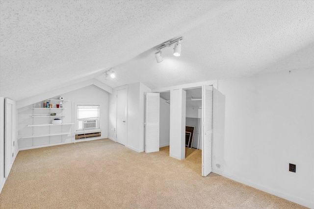 bonus room with a textured ceiling, light colored carpet, cooling unit, baseboard heating, and lofted ceiling