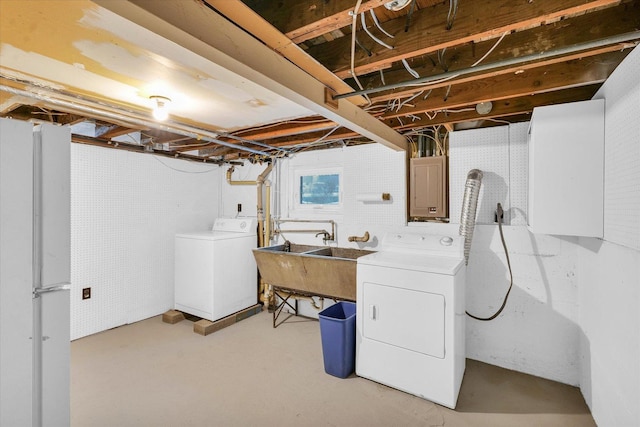 clothes washing area featuring separate washer and dryer, sink, and electric panel