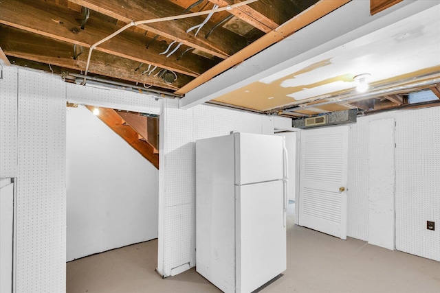 basement with white fridge