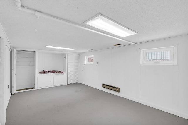 basement with a healthy amount of sunlight and a textured ceiling