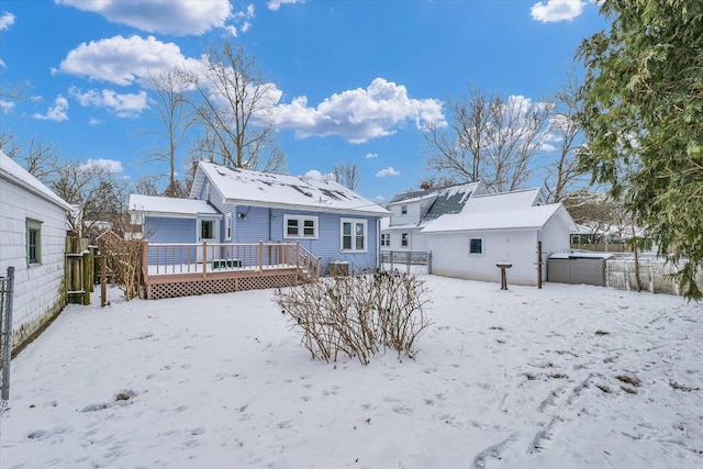 snow covered property with a wooden deck