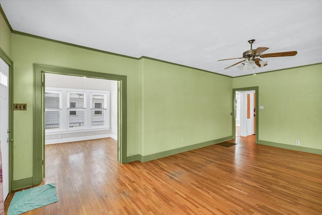 unfurnished room with light hardwood / wood-style flooring, ceiling fan, and crown molding