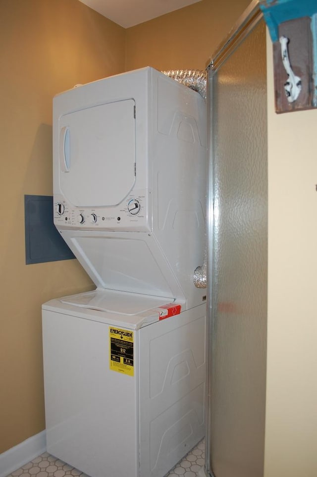 laundry room with stacked washer / dryer