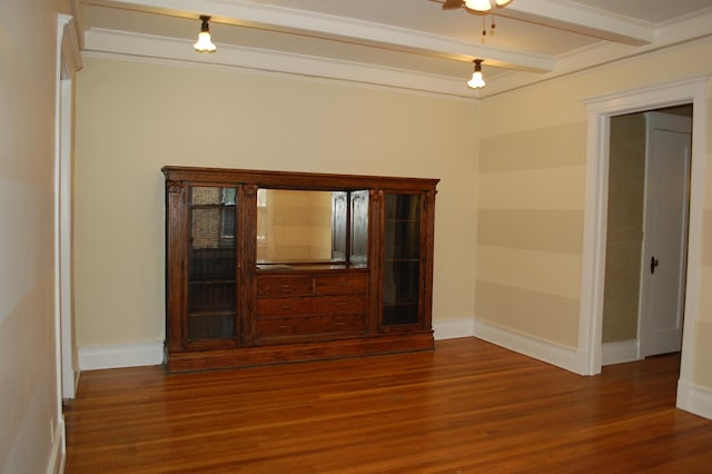 empty room with ceiling fan, beam ceiling, dark hardwood / wood-style flooring, and ornamental molding