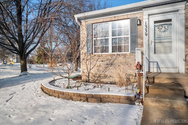 view of snow covered property entrance