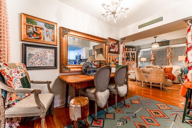 interior space with dark hardwood / wood-style floors and an inviting chandelier