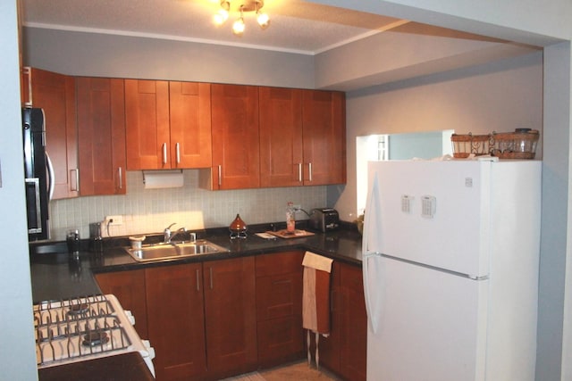 kitchen featuring tasteful backsplash, sink, and white refrigerator