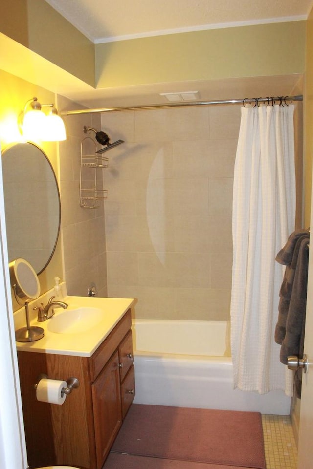 bathroom featuring vanity and shower / bathtub combination with curtain