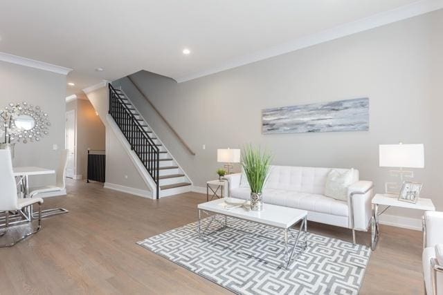 living room featuring light wood-type flooring and ornamental molding