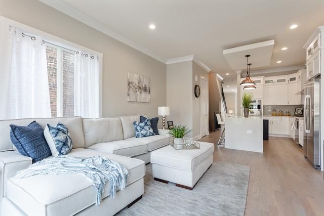 living room featuring light hardwood / wood-style flooring and ornamental molding