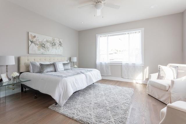 bedroom with ceiling fan and wood-type flooring