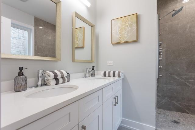 bathroom featuring vanity and a tile shower