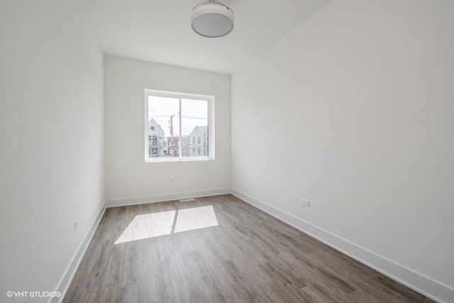 unfurnished room featuring hardwood / wood-style flooring