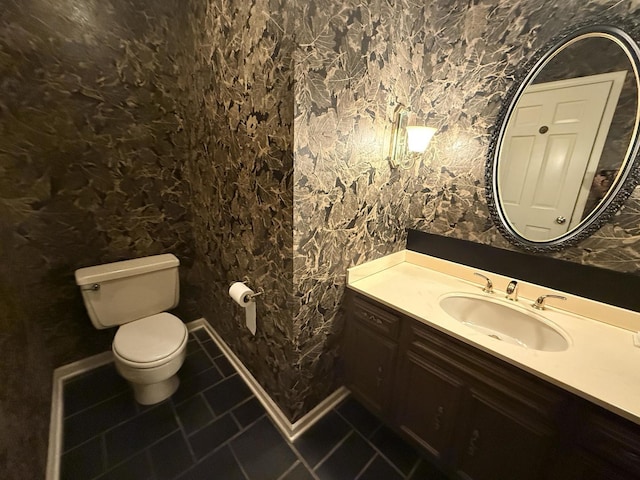 bathroom with tile patterned floors, vanity, and toilet