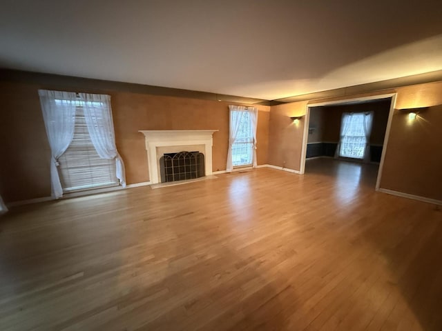 unfurnished living room featuring hardwood / wood-style floors