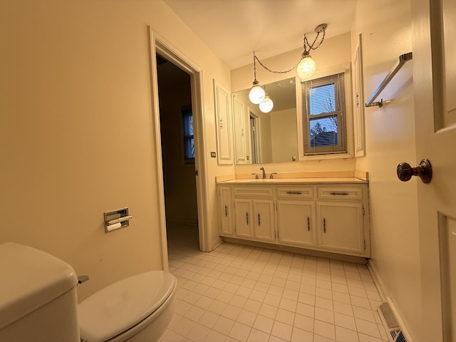 bathroom featuring tile patterned floors, vanity, and toilet