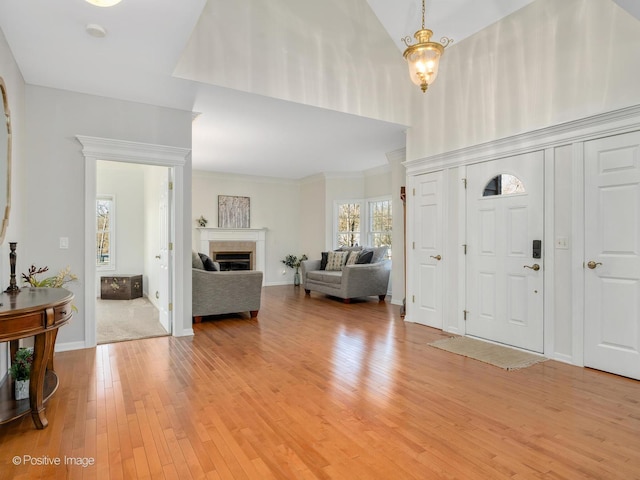 entryway with light hardwood / wood-style floors and an inviting chandelier