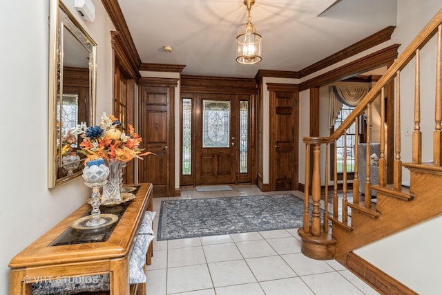 foyer with crown molding, light tile patterned floors, and a notable chandelier