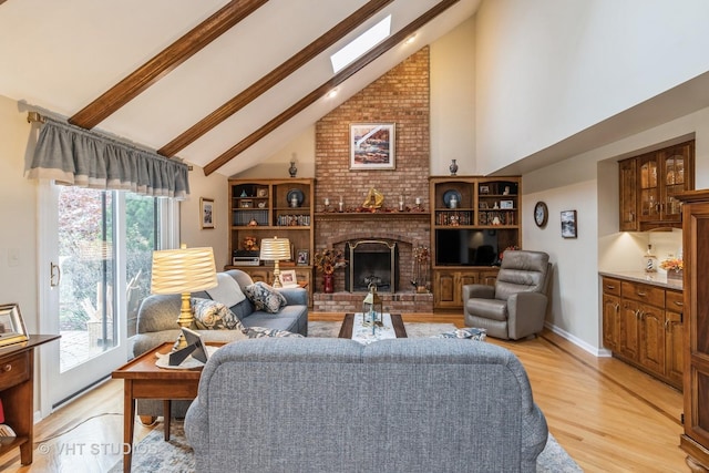 living room featuring plenty of natural light, light hardwood / wood-style floors, high vaulted ceiling, and a brick fireplace