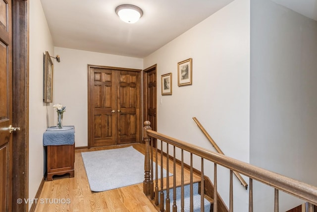 hallway with light hardwood / wood-style floors