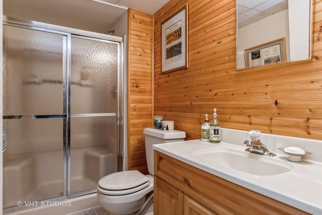 bathroom with toilet, an enclosed shower, and wood walls