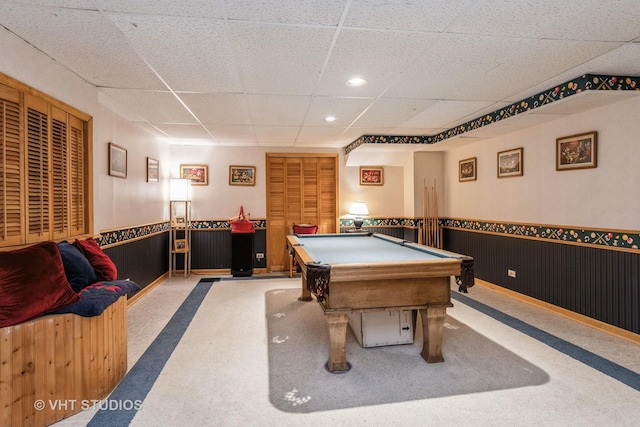 rec room with wood walls, a drop ceiling, and pool table