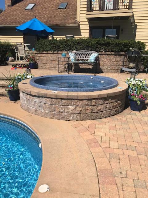 view of swimming pool with a patio area