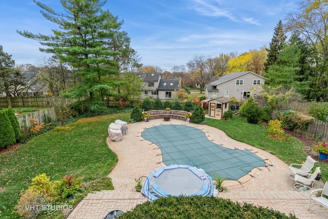 view of pool featuring a yard and a patio