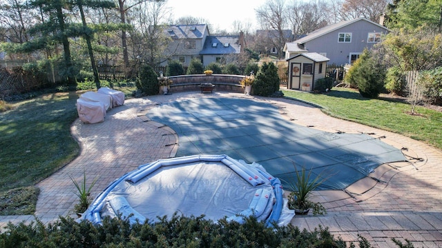 view of swimming pool featuring a yard, a patio, and a hot tub