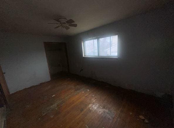 spare room with ceiling fan and dark hardwood / wood-style flooring