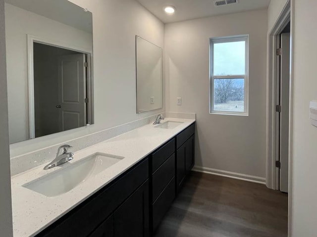 kitchen with white cabinets, stainless steel appliances, light hardwood / wood-style flooring, and light stone counters