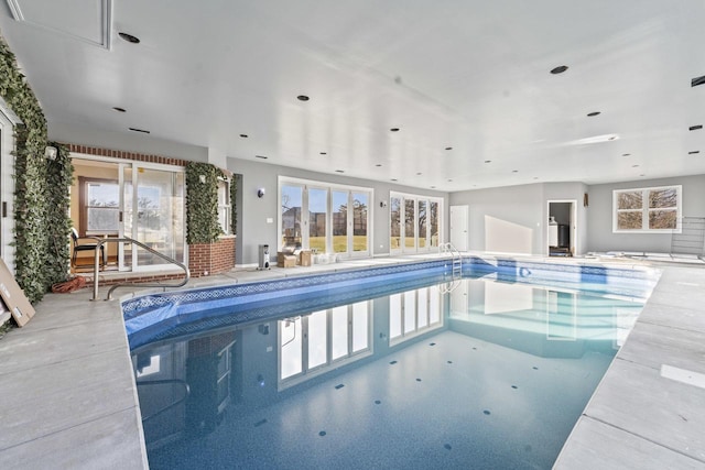 view of pool with a hot tub