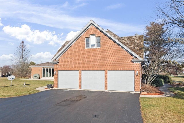 view of side of property with a lawn and a garage