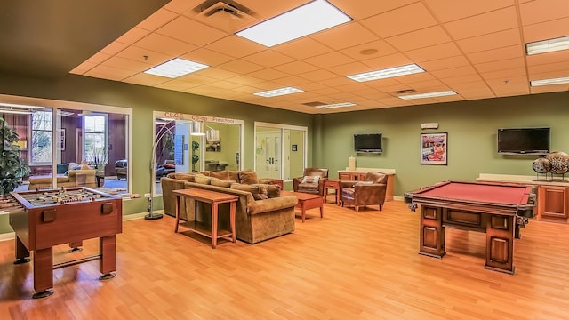 rec room with light wood-type flooring, a paneled ceiling, and billiards