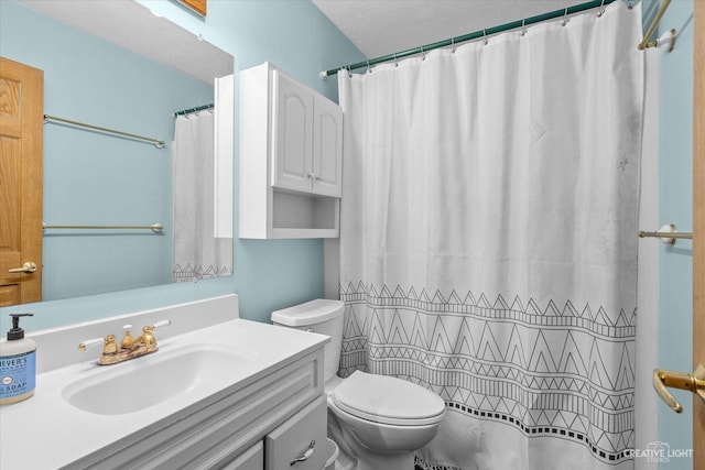 bathroom with a shower with shower curtain, a textured ceiling, vanity, and toilet