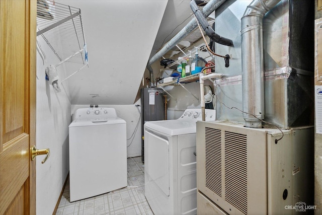 laundry area with heating unit, washer and clothes dryer, and gas water heater