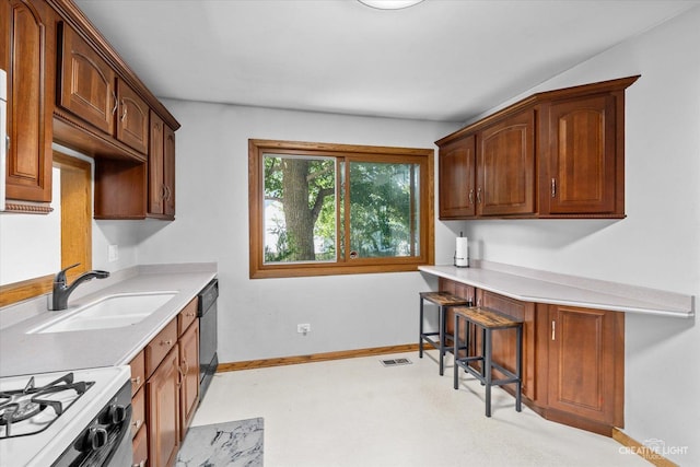 kitchen featuring black dishwasher, a kitchen bar, sink, and white range oven