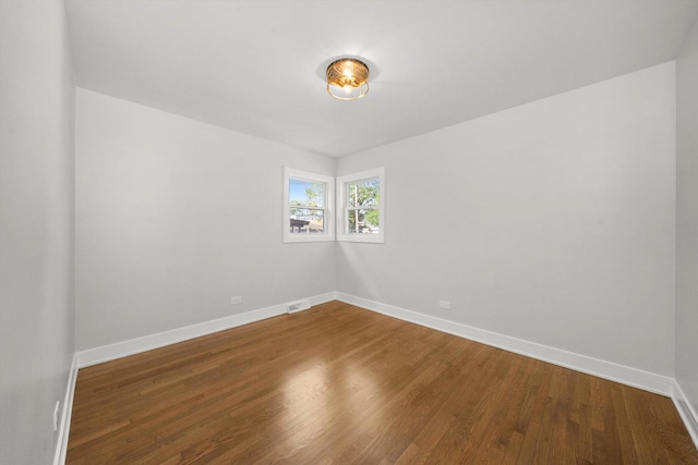 unfurnished room featuring hardwood / wood-style flooring