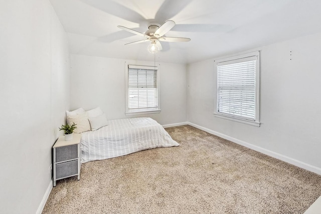 bedroom with carpet, ceiling fan, and multiple windows