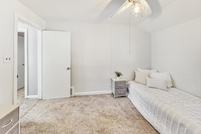 carpeted bedroom with ceiling fan and vaulted ceiling