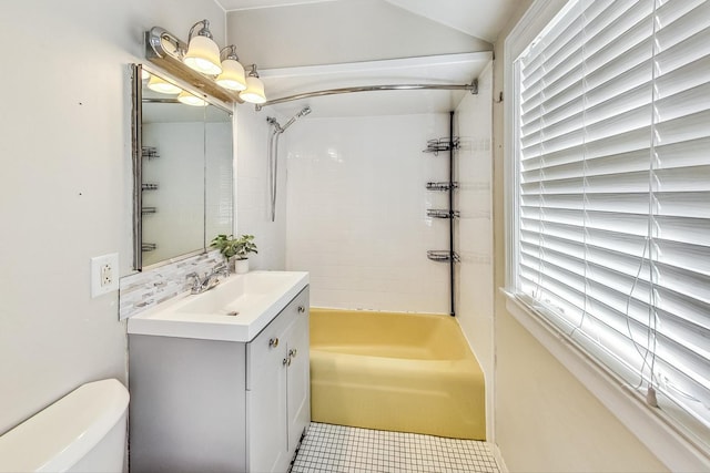 full bathroom featuring tiled shower / bath combo, toilet, and vanity