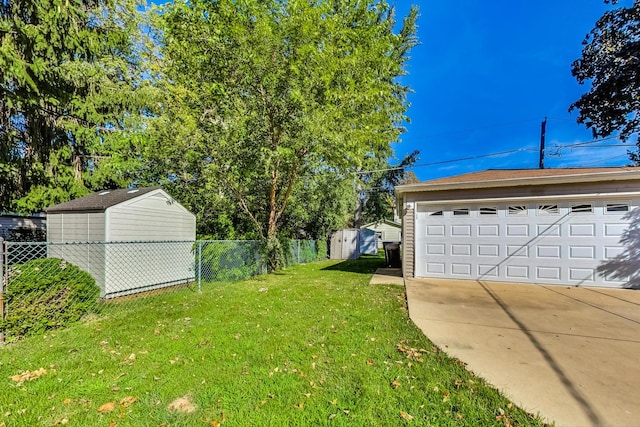 view of yard featuring a garage and a storage unit